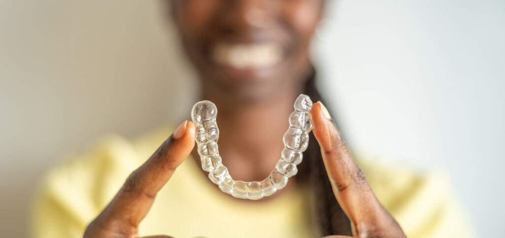 Woman Holding Dental Aligners