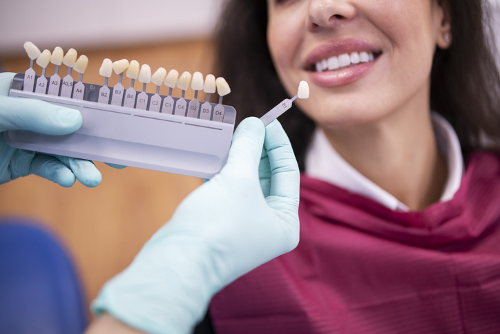 Dentist Matching The Right White Tone For A Dental Crown.