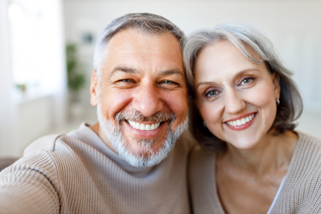 Portrait Of Happy Beautiful Senior Caucasian Couple Smiling At Camera While Making Selfie
