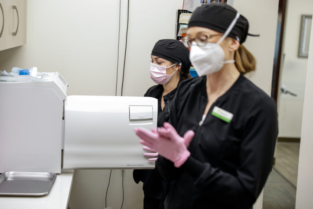 Dr. Hadley Thurmon and a nurse operating dental equipment.
