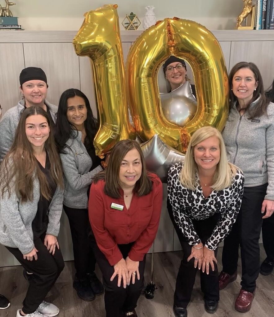 10 Year Anniversary with the full staff round a "10" shaped balloon